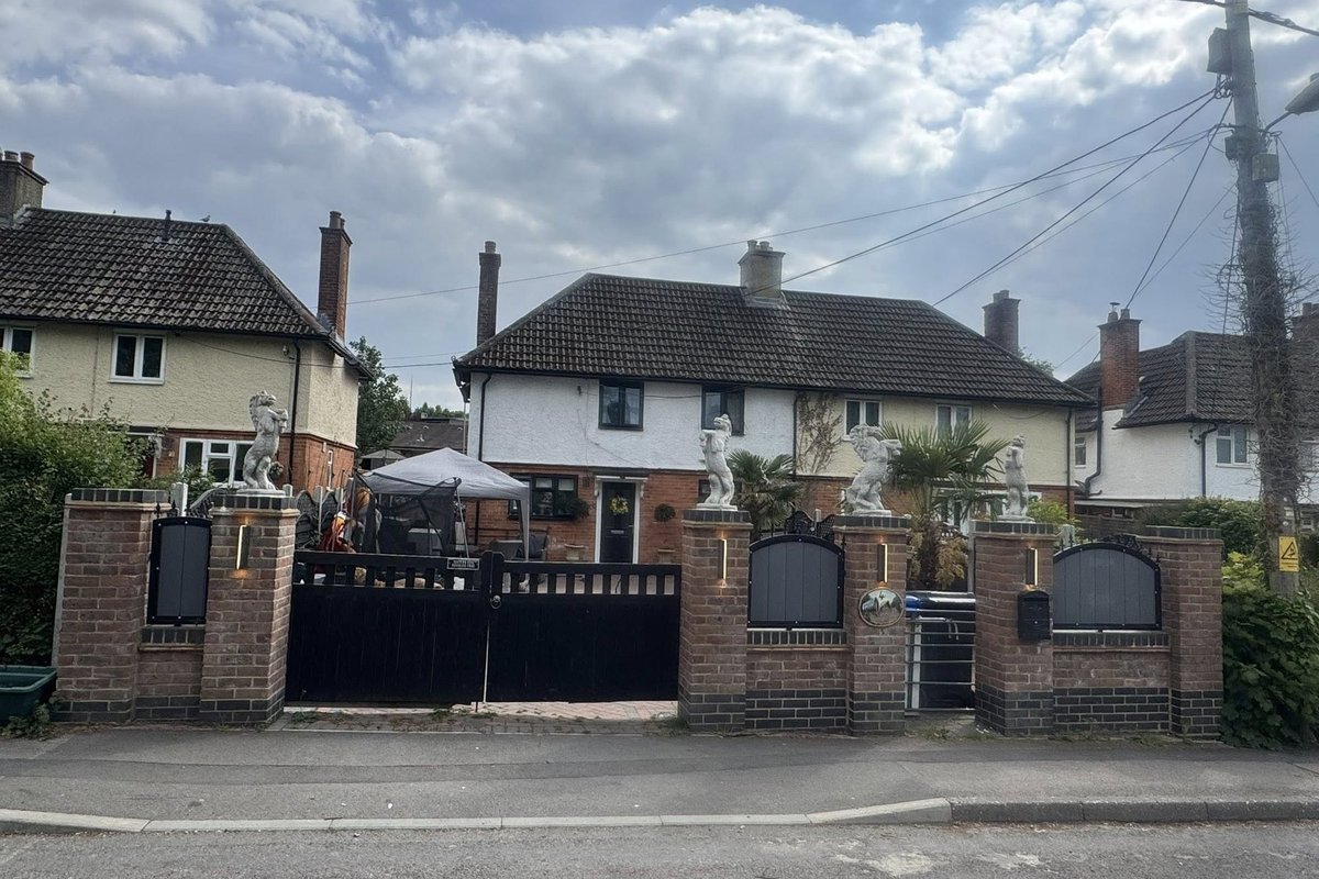 Neighbour row erupts after travellers built wall topped with giant horse statues and accuse locals of 'not liking Gypsies'