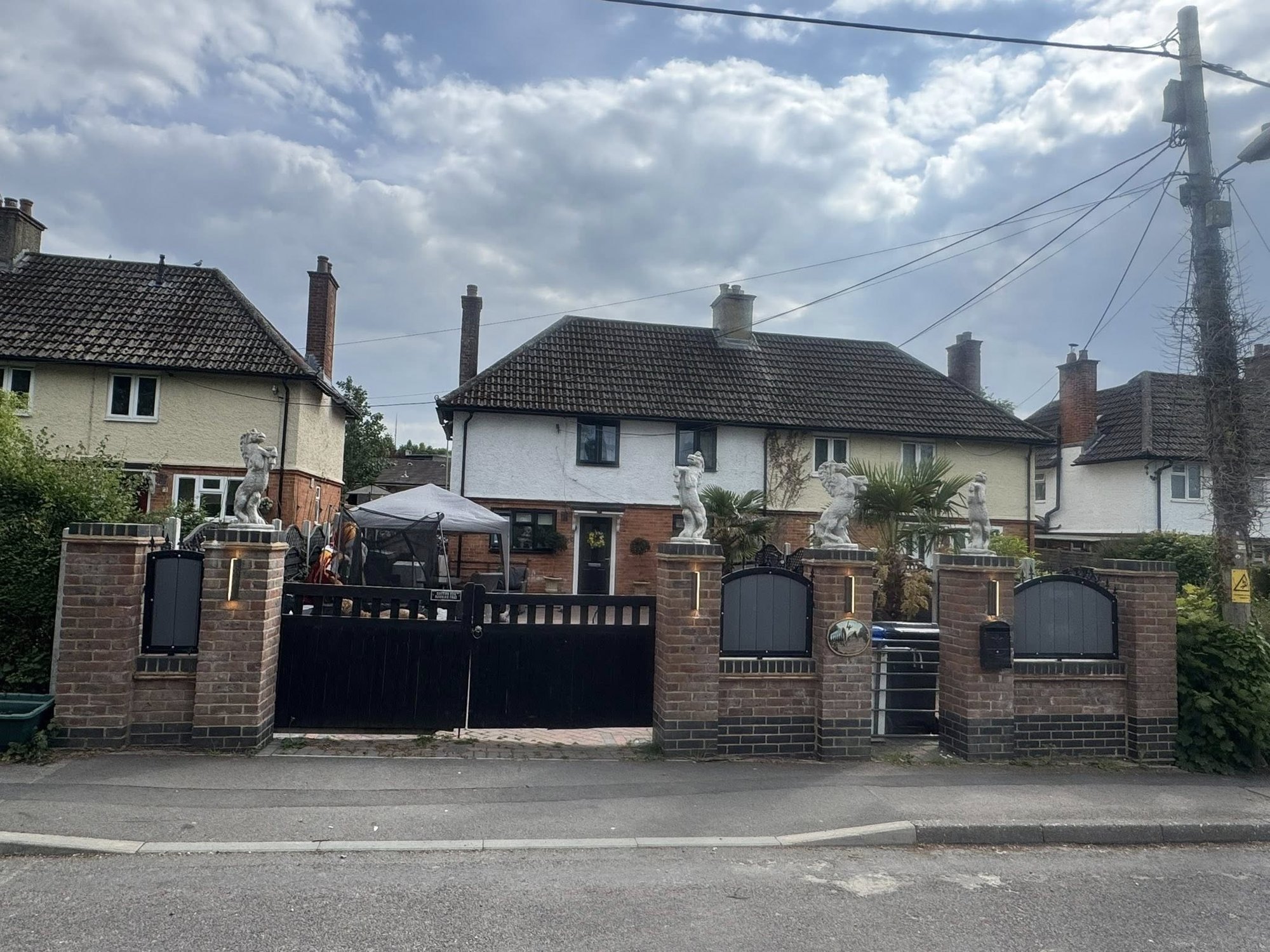 Neighbour row erupts after travellers built wall topped with giant horse statues and accuse local...
