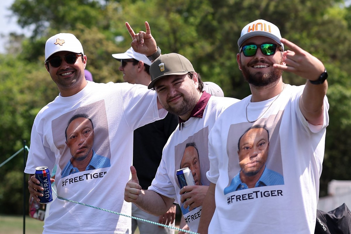 Golf fans seen wearing shirts of Tiger Woods mugshot during tournament after legend's arrest