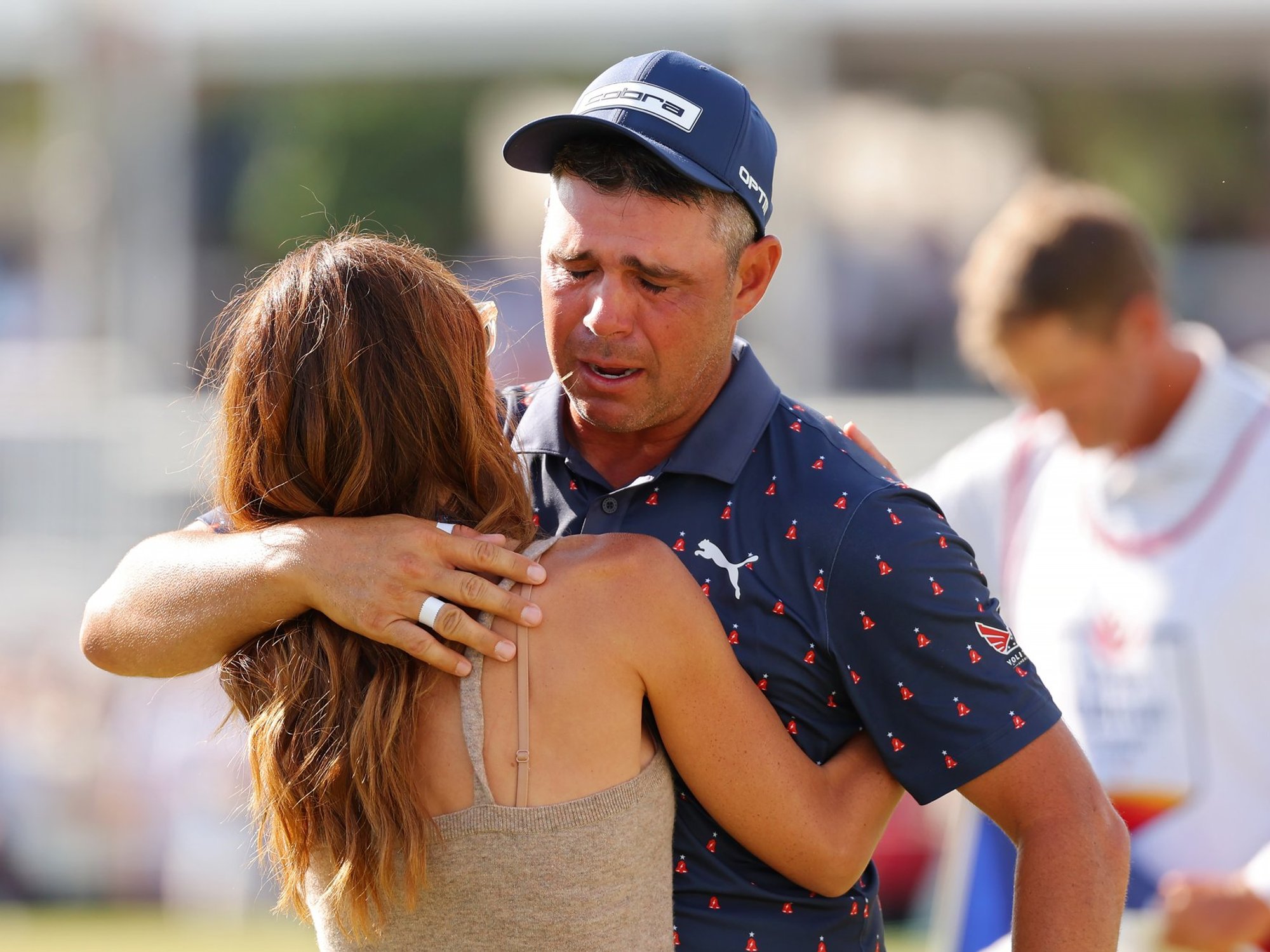 Golf star breaks down in tears and hugs wife after winning first tournament since life-or-death surgery