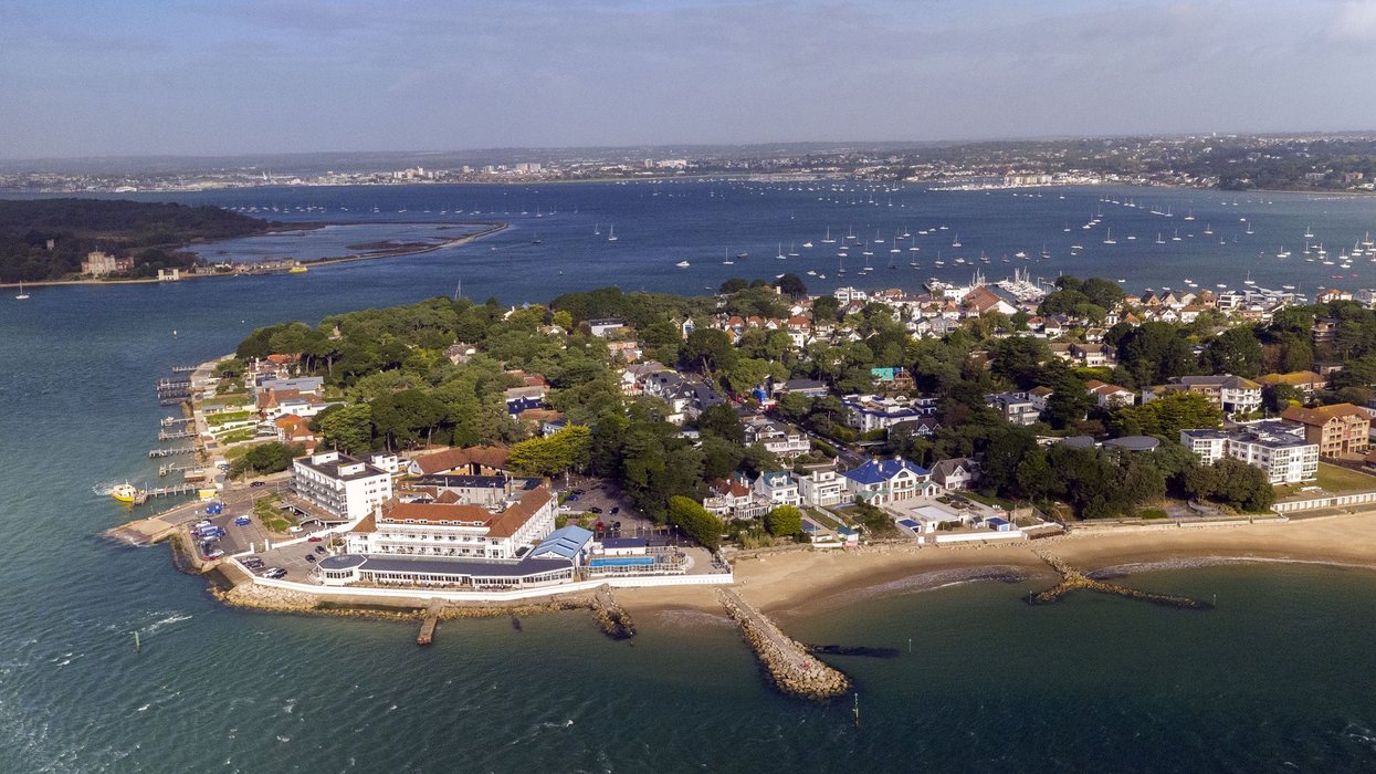 Homeowner wins feud with neighbours over 7ft-tall 'Berlin Wall' built around £1million seaside home
