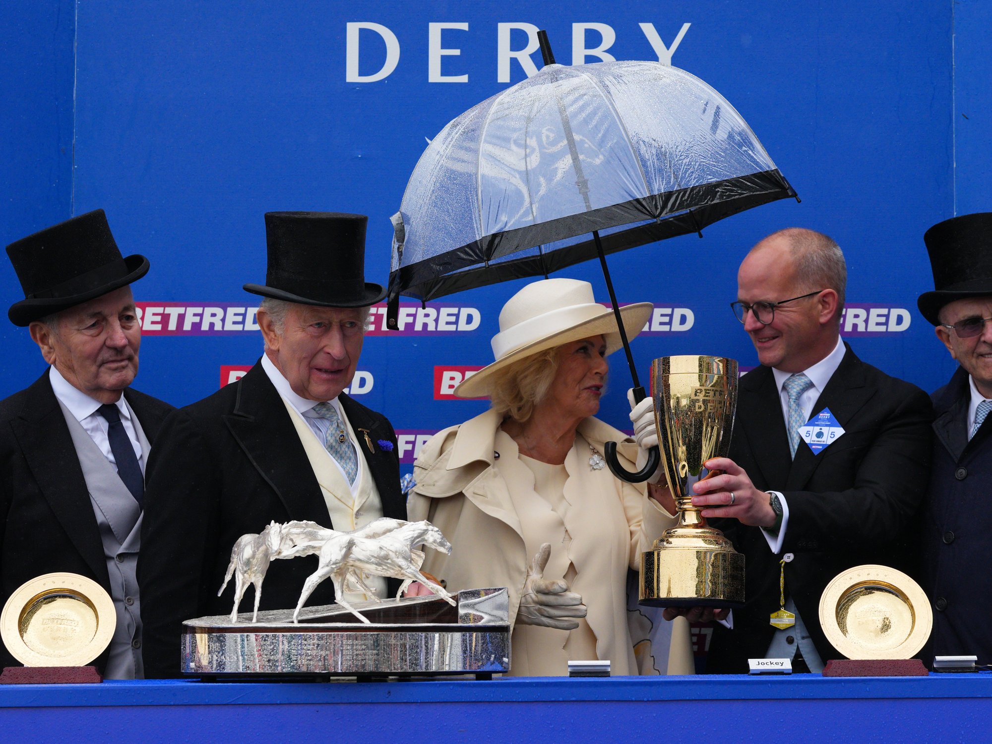 King and Queen hand out prestigious trophy at Epsom just hours after watching Peter Phillips wedding