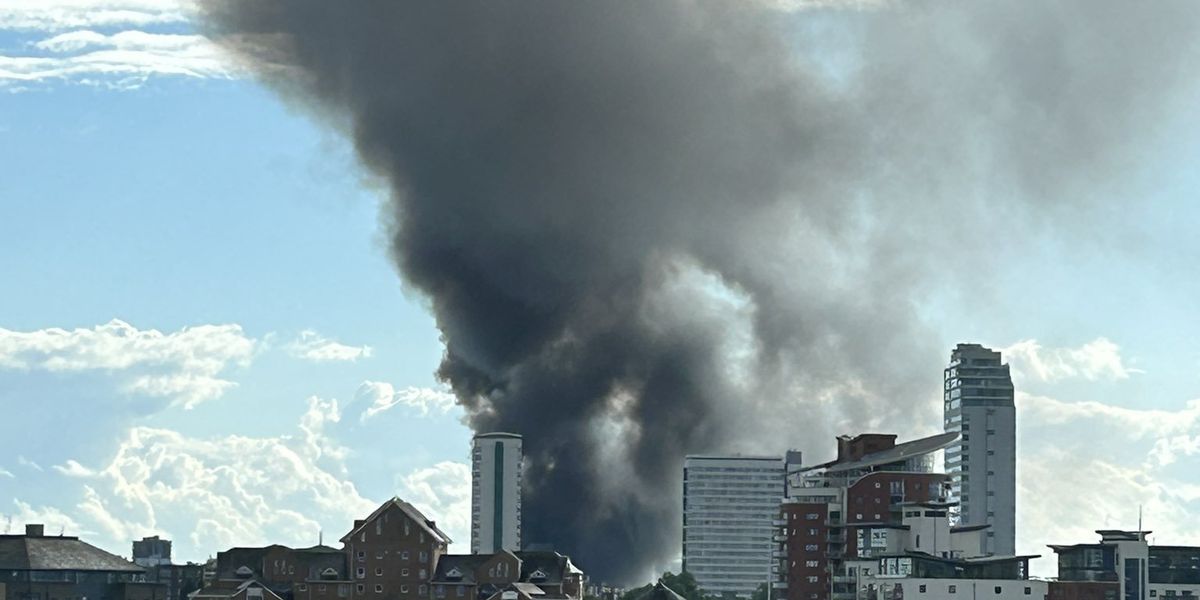 Firefighters rush to tackle huge blaze at Isle of Dogs as plumes of smoke soar into London's skies
