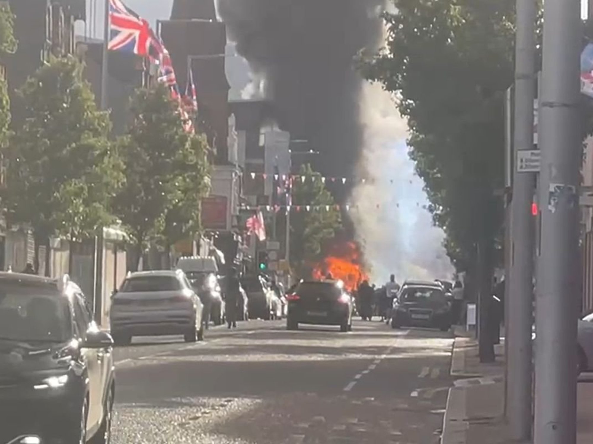 Belfast bus set on fire as hundreds stage protest after Sudanese migrant charged with attempted murder