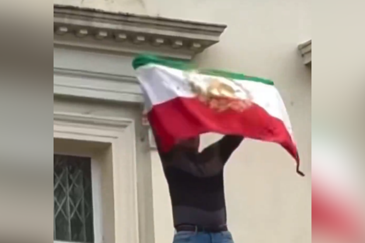 Protester rips flag off Iranian Embassy in London as demonstrations reach Britain