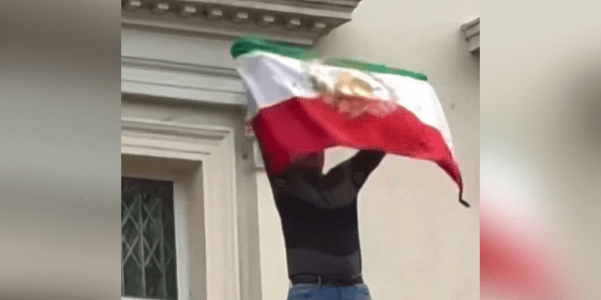 Protester rips flag off Iranian Embassy in London as demonstrations reach Britain Protester rips flag off Iranian Embassy in London as demonstrations reach Britain