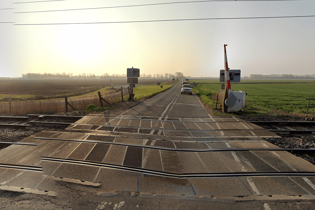 One person killed and another injured after train crashes into car at level crossing