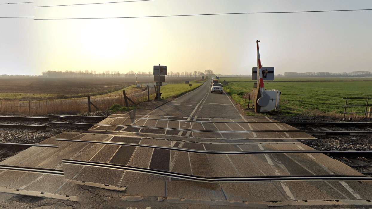 One person killed and another injured after train crashes into car at level crossing