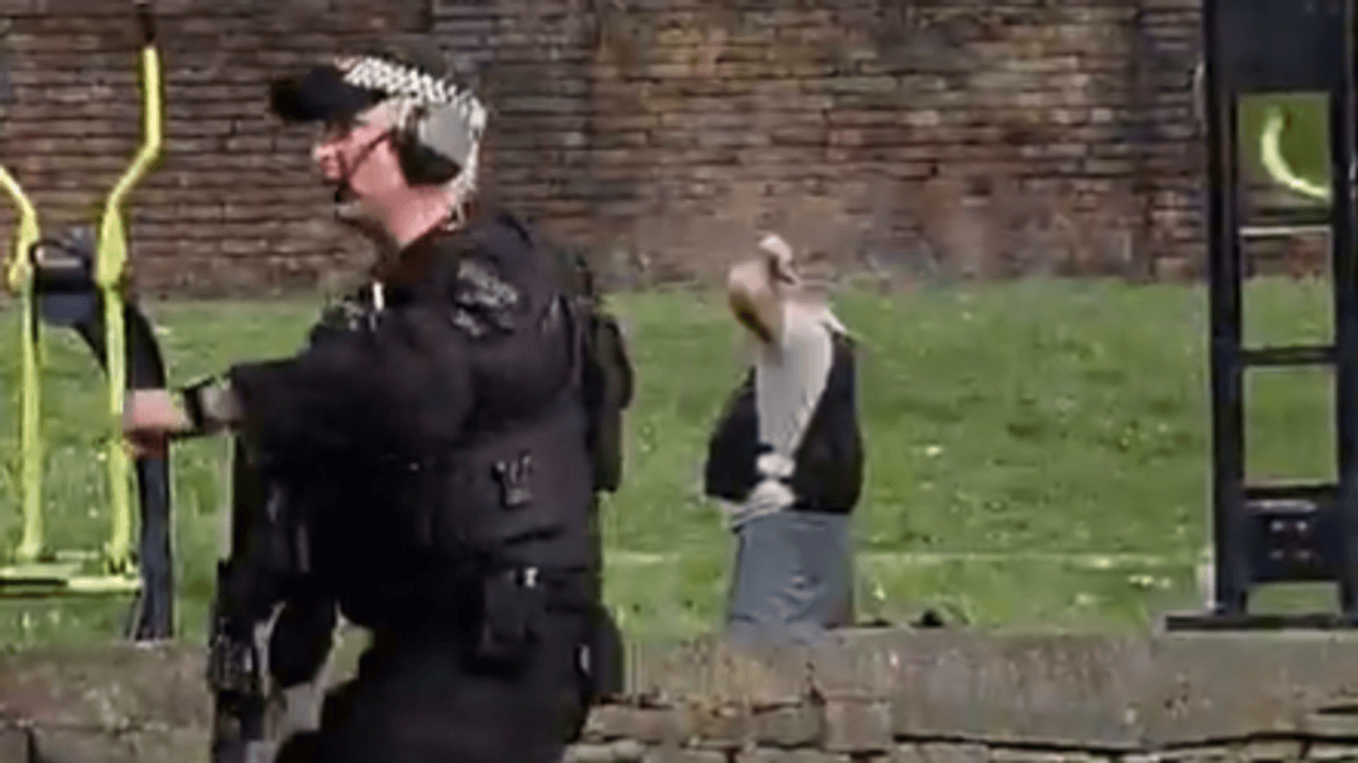 Armed police swarm Manchester park after man seen wearing 'suicide vest'... but the reality is not what it seems