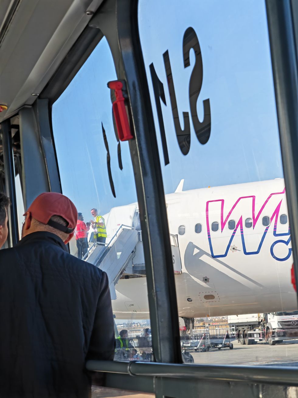 Images show passengers stuck in the bus while workers stood outside