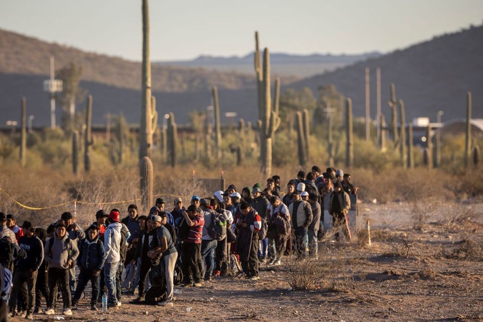 Immigrants line up at a remote US Border Patrol in Lukeville, Arizona
