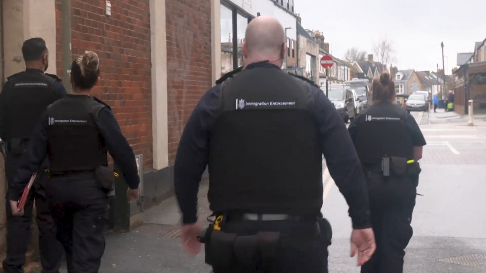 Immigration officers before raid on barbershop