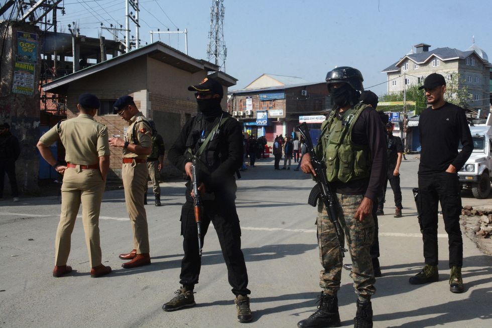 Indian police officers stand guard outside the police control room in Srinagar, following a suspected militant attack near south Kashmir's scenic Pahalgam