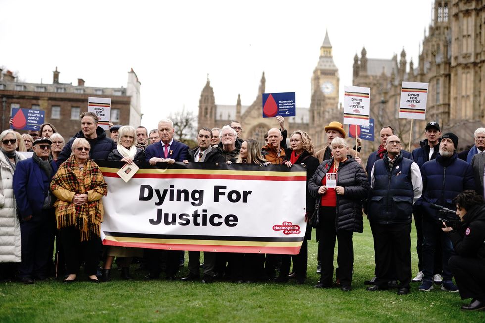 Infected blood victims and campaigners protest on College Green in Westminster, London