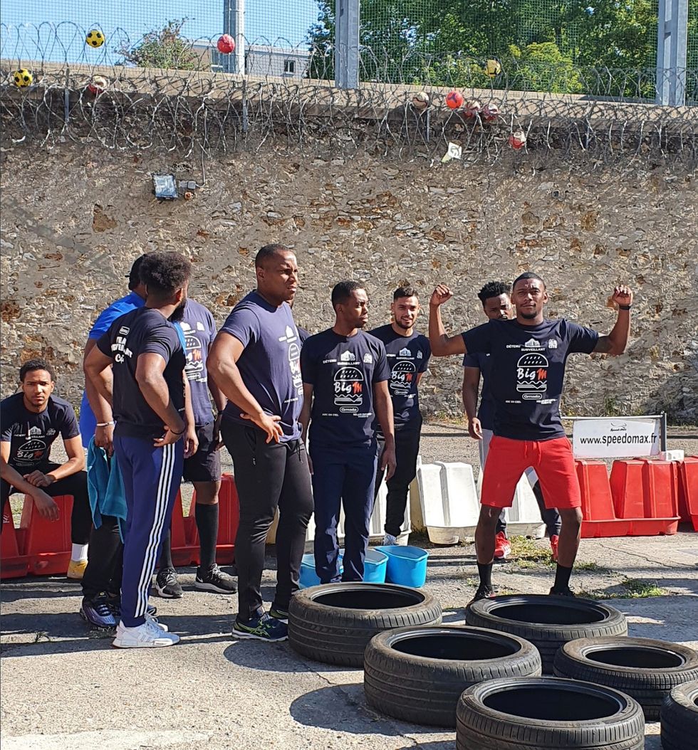 Inmates taking part in an obstacle course.