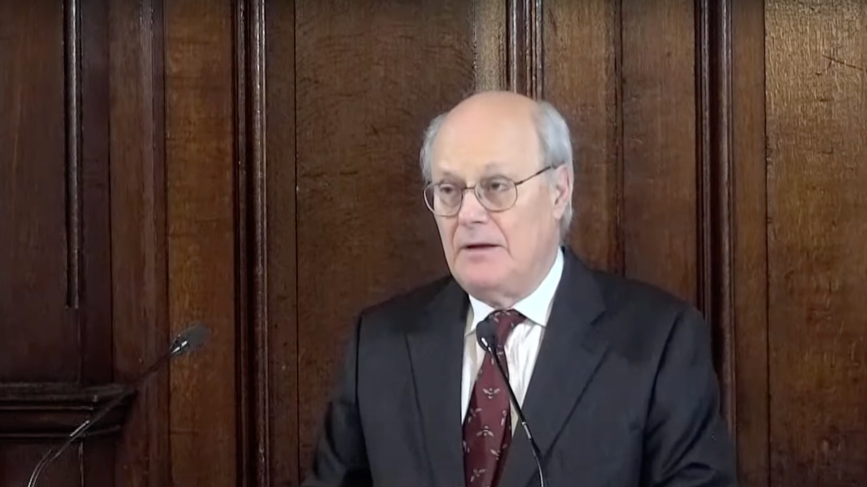 Inquiry chairman Sir John Saunders reads a statement