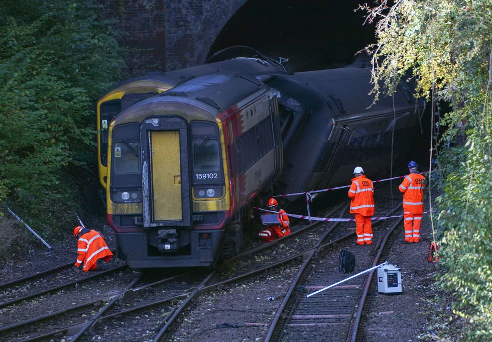 Investigators at the scene of a crash involving two trains near the Fisherton Tunnel between Andover and Salisbury in Wiltshire.