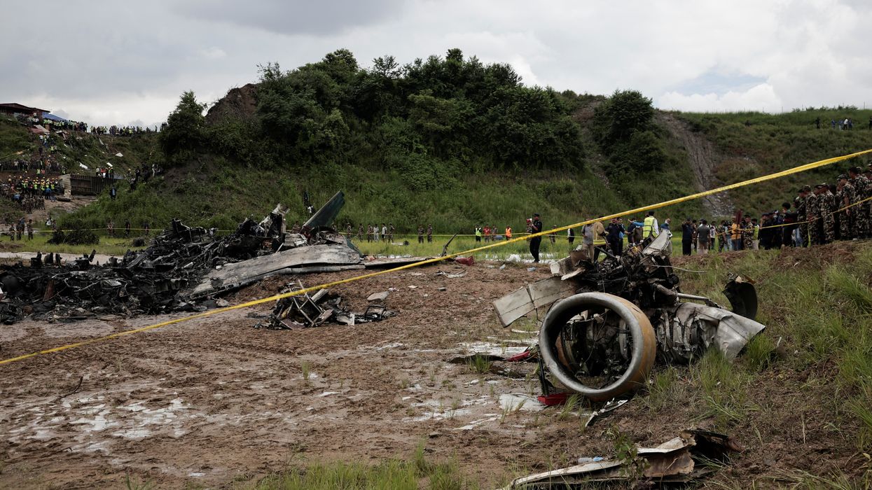 Investigators at the scene of the crash in Nepal