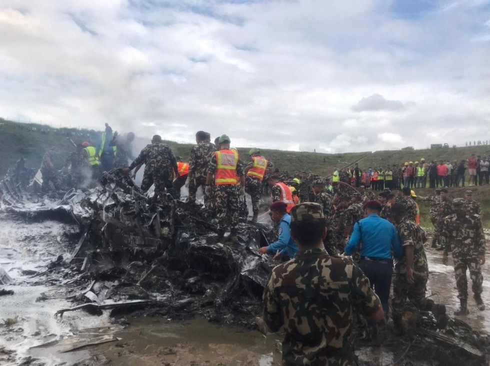 Investigators at the scene of the crash in Nepal