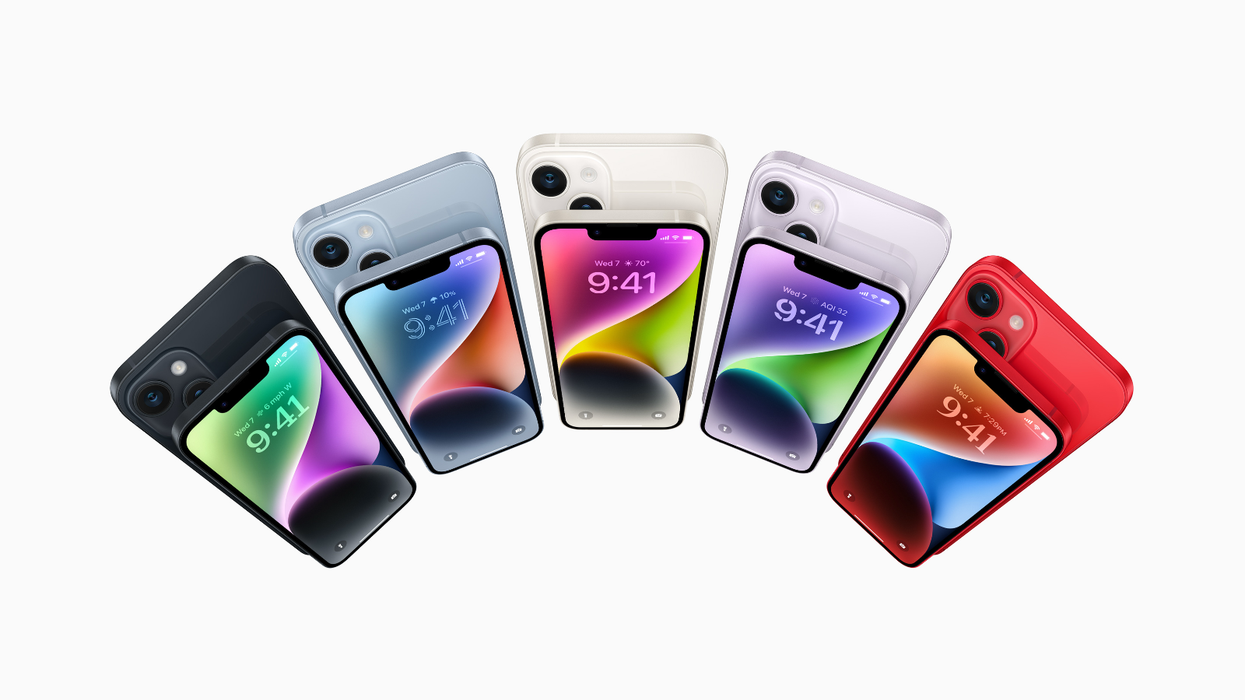 iPhone 14 pictured in all five colour options in a semi-circle