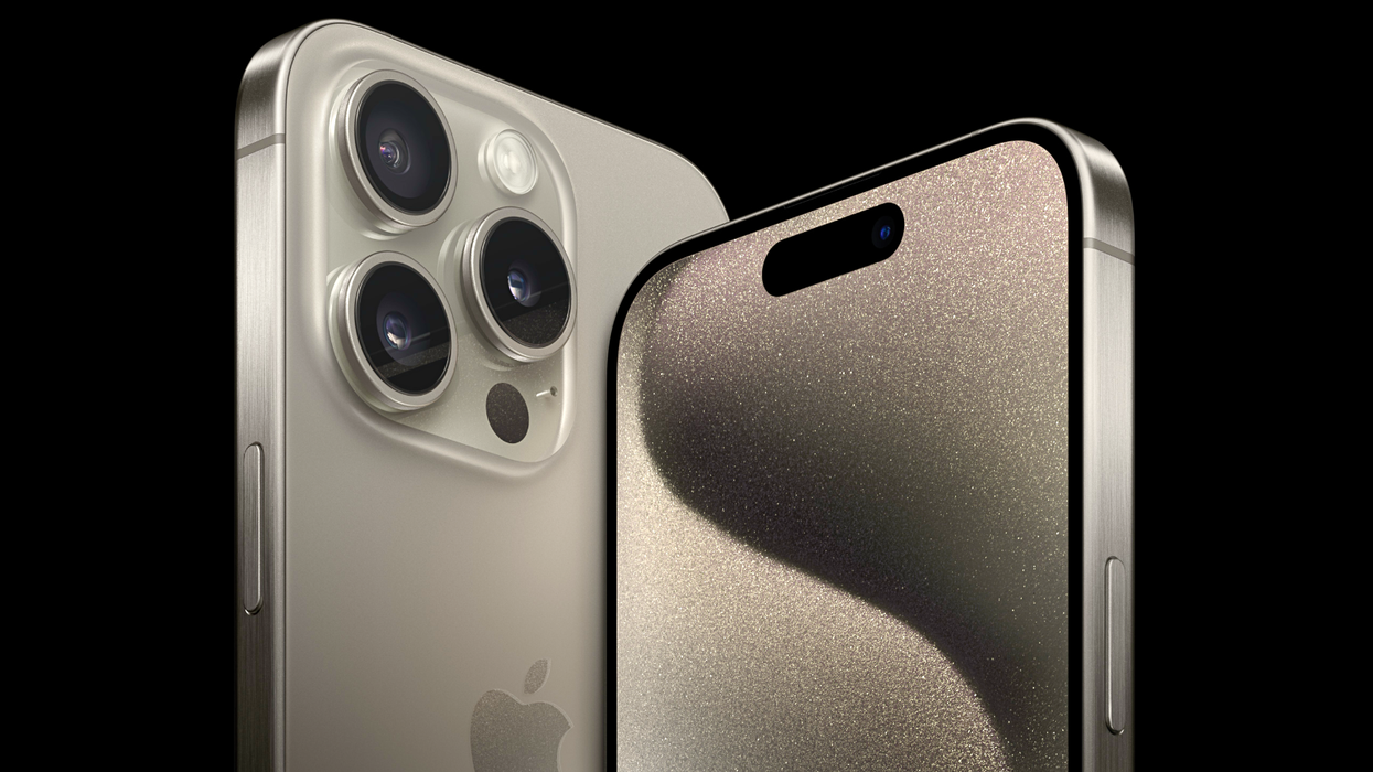 iphone 15 pro max in titanium on a black background