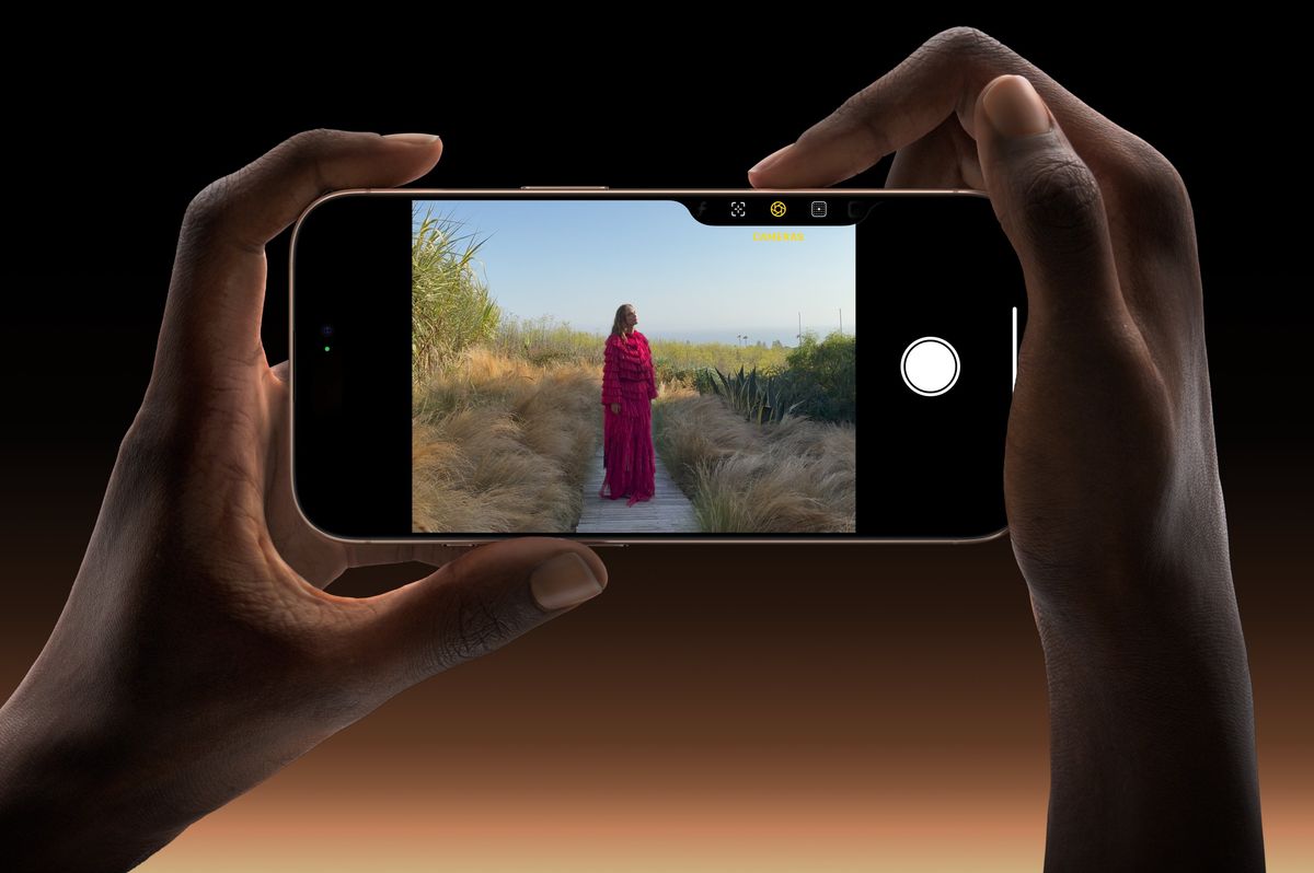 iphone 16 Pro held in landscape with someone using the camera control button to compose a photograph