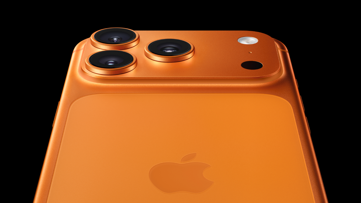 iPhone 17 Pro Max pictured in Cosmic Orange on a black background