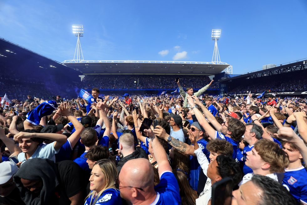 Ipswich fans celebrate their promotion to the Premier League following their win over QPR