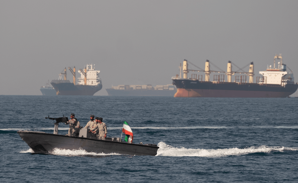Iranian Navy soldiers at an armed speed boat in Persian Gulf near the strait of Hormuz about 1320km (820 miles) south of Tehran