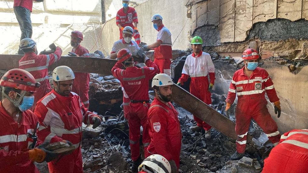 Iranian Red Crescent Society members search through the rubble for victims after Israeli strikes\u200b