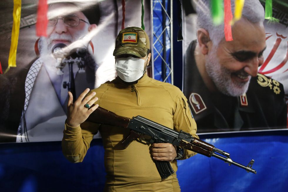 Iranian solider holding a gun