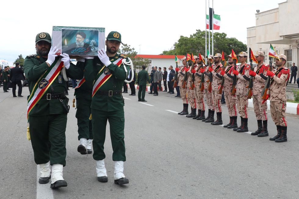 IRGC members holding Raisi's casket