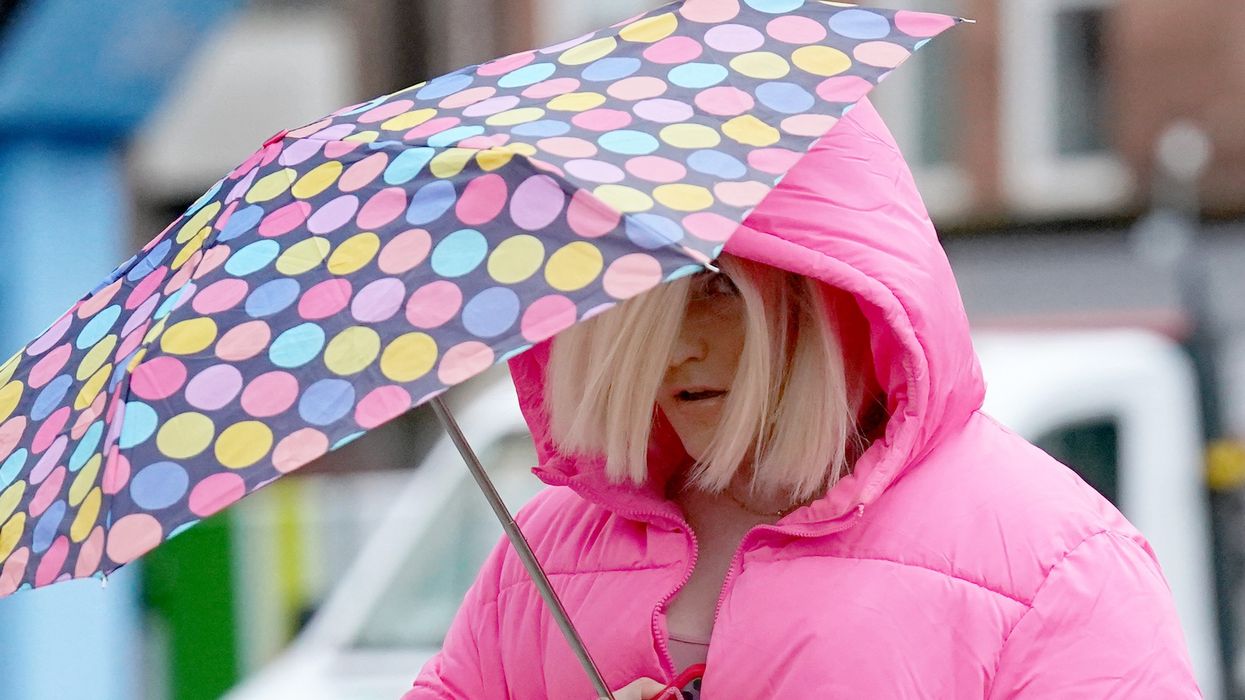 Isla Bryson walking with an umbrella