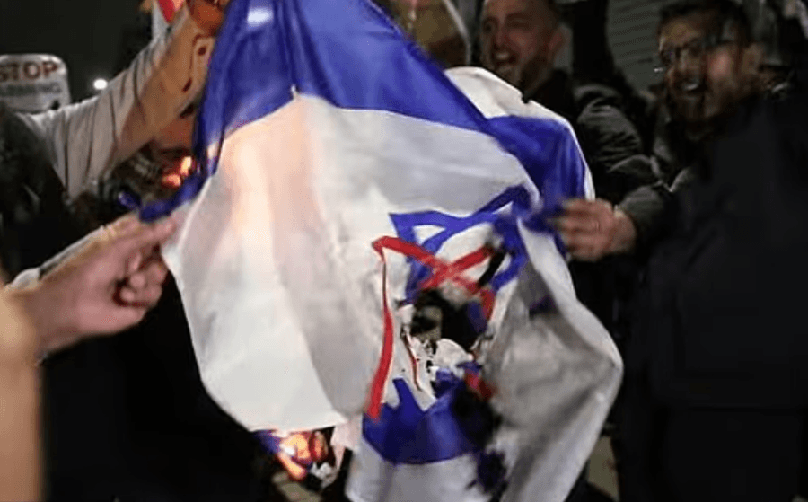 Israeli flag being burned by protesters