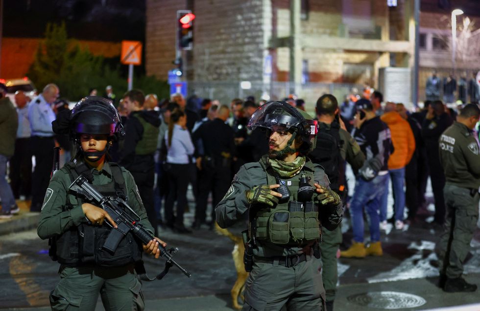 Israeli forces stand guard near the scene of a shooting attack in Neve Yaacov which lies on occupied land that Israel annexed to\u00a0Jerusalem\u00a0after the 1967 Middle East war January 27, 2023. REUTERS/Ronen Zvulun
