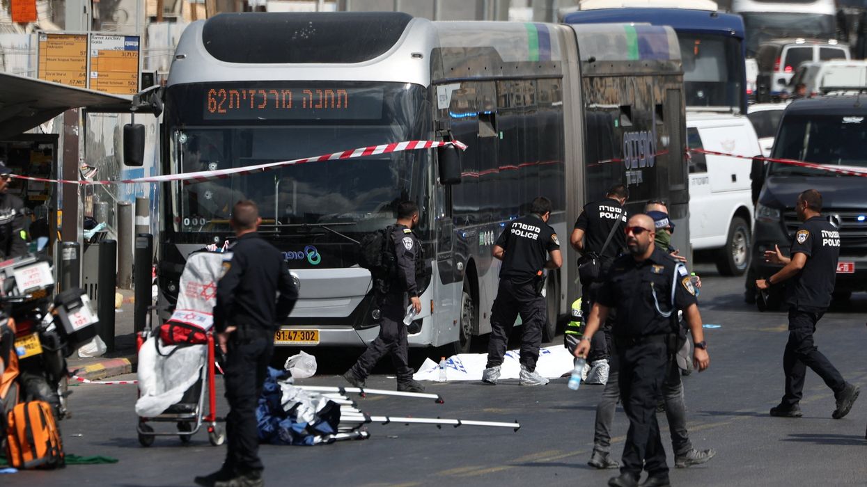 Israeli police officers work at the scene where a suspected shooting attack took place at the outskirts of Jerusalem