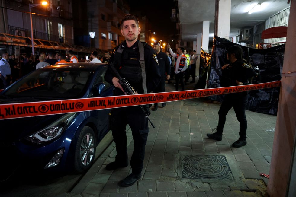 Israeli security officials secure the scene of a fatal shooting attack on a street in Bnei Brak, near Tel Aviv, Israel, March 29, 2022. REUTERS/Nir Elias