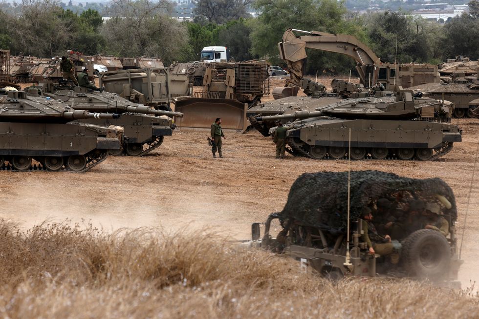 Israeli tanks and military vehicles amass at the Israeli side of the Gaza border