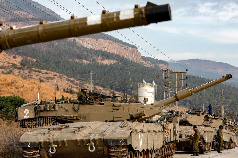 Israeli tanks situated on the border with Lebanon