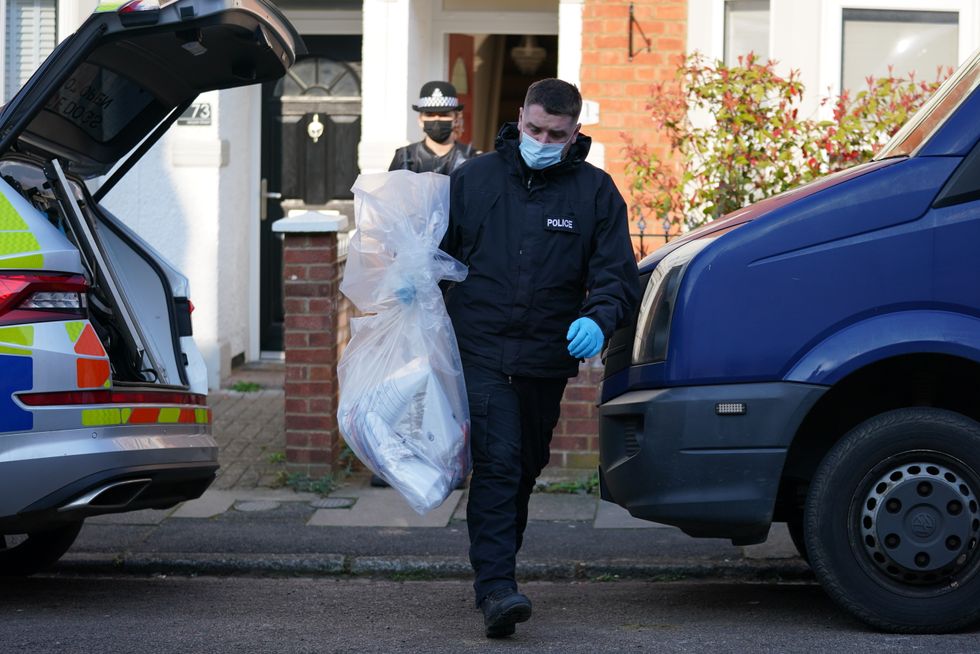 Items are removed from the property in Moore Street, Kingsley, Northampton following a discovery of a body in a rear garden.