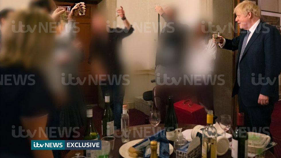 ITV handout photo dated 13/11/20 of a photograph obtained by ITV News of the Prime Minister raising a glass at a leaving party on 13th November 2020, with bottles of alcohol and party food on the table in front of him. Issue date: Monday May 23, 2022.