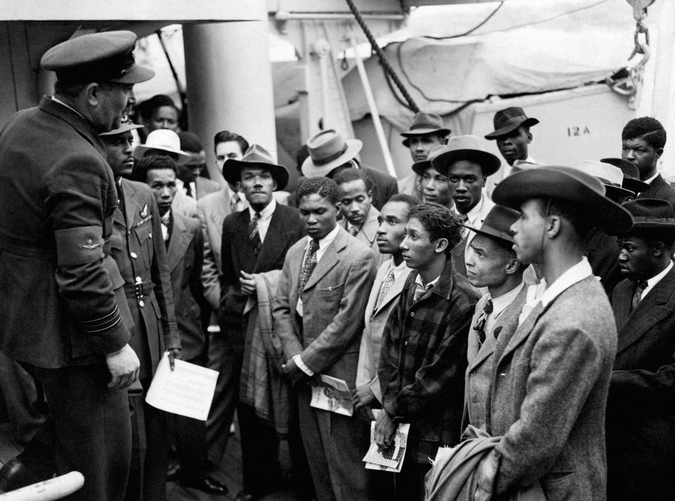 Jamaican immigrants welcomed by RAF officials from the Colonial Office after the ex-troopship HMT 'Empire Windrush' landed them at Tilbury