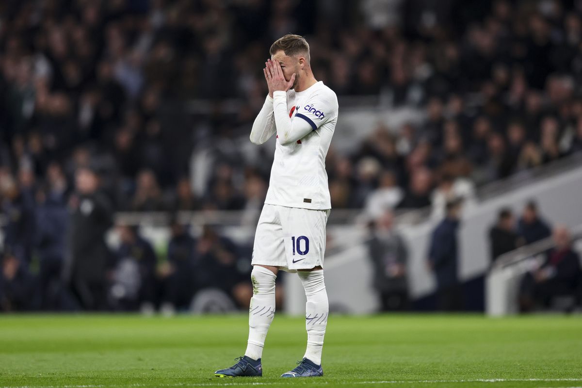 James Maddison puts his hands to his face in anguish.