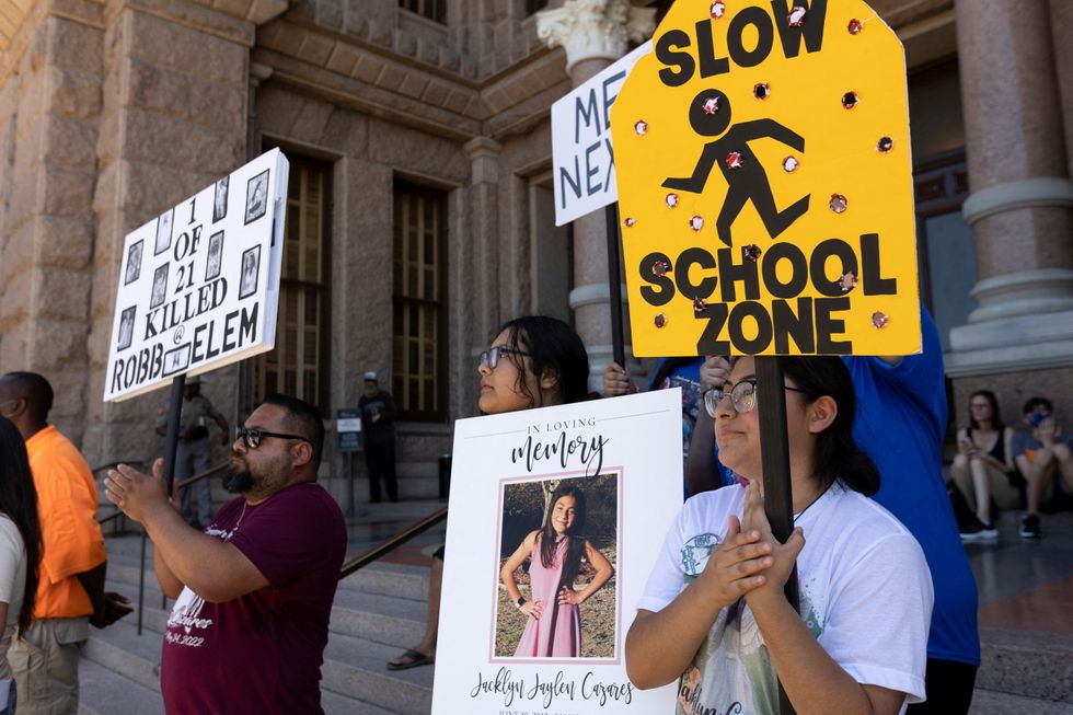 Jazmin Cazares, 17, sister of Jackie Cazares, one of the victims of the Robb Elementary School shooting in Uvalde, Texas, holds a sign with mock bullet holes symbolizing the 21 victims, during a \%22March for Our Lives\%22 rally, one of a series of nationwide protests against gun violence, in Austin, Texas, US.