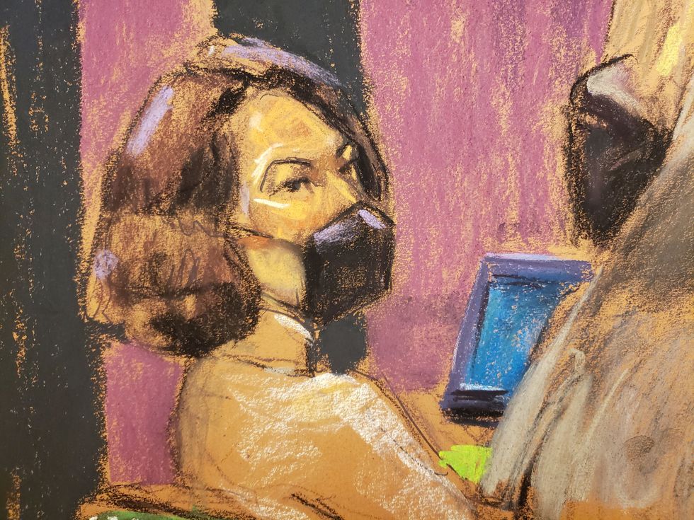 Jeffrey Epstein associate Ghislaine Maxwell sits with defense lawyers discussing how to respond to a jury's note, as deliberations extended into a second week in a courtroom sketch in New York City, U.S., December 27, 2021. REUTERS/Jane Rosenberg