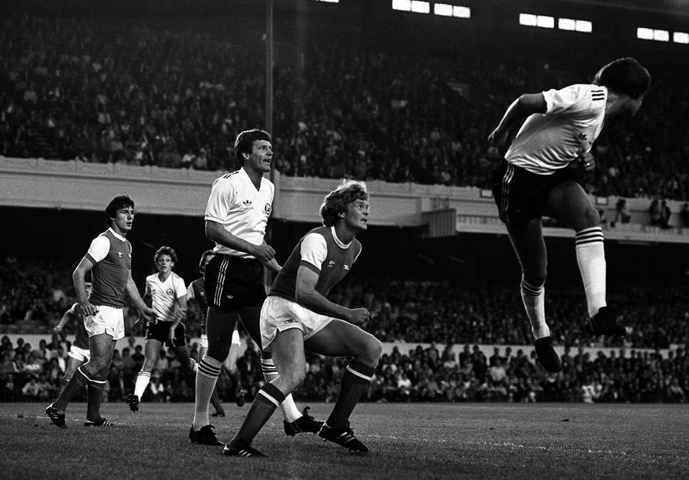 Jeremy Charles heads clear from Willie Young, watched by Swansea's captain John Toshack (far left) during the football league cup 2nd-round match against Arsenal at Highbury.