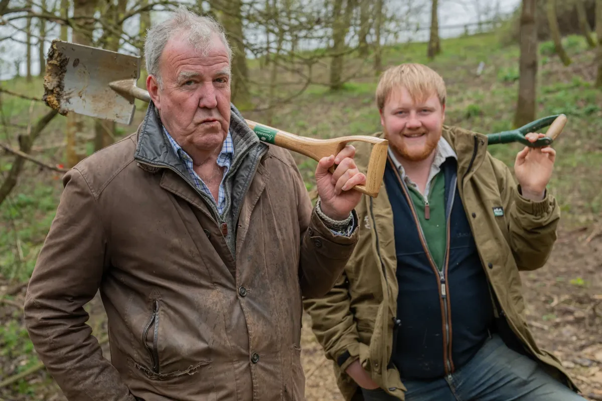 jeremy clarkson and kaleb cooper pictured holding spades in the forest 