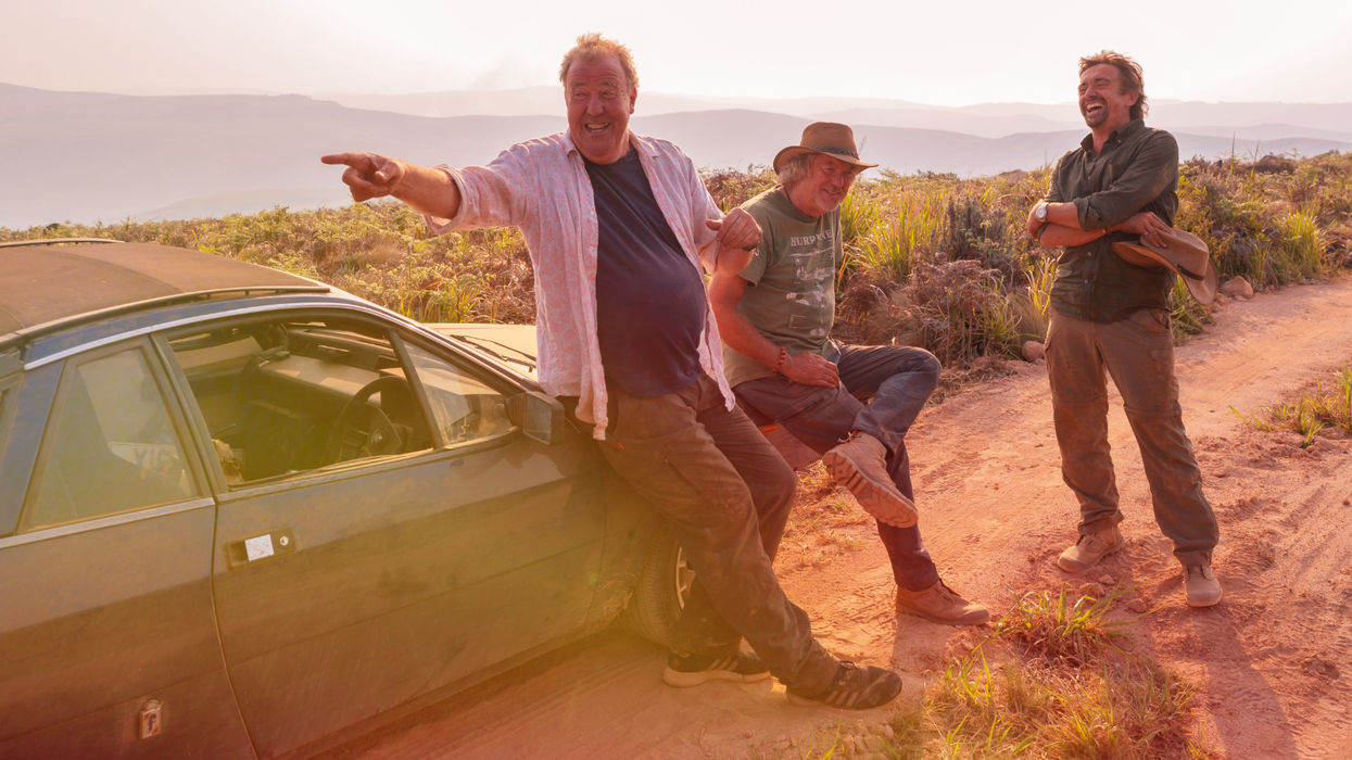 jeremy clarkson james may and richard hammond stand on a dirt track in zimbabwe while filming the last episode of The Grand Tour