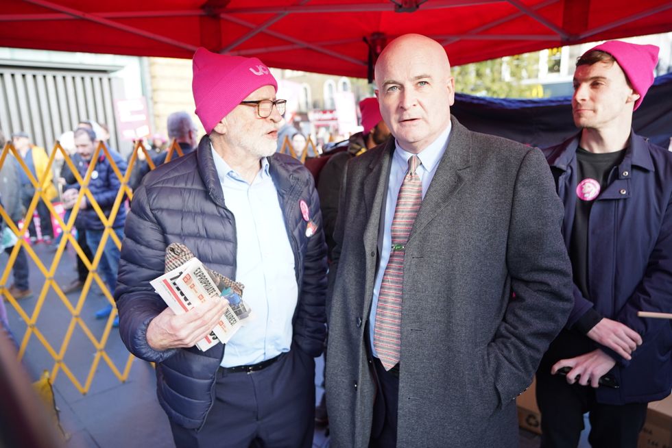 Jeremy Corbyn (left) and Mick Lynch, general secretary of the Rail, Maritime and Transport union (RMT), (centre) join protesters during a rally outside Kings Cross Station, London, as members of the University and College Union (UCU) take part 24-hour stoppage among university staff in an ongoing dispute over pay, pensions and conditions. Picture date: Wednesday November 30, 2022.