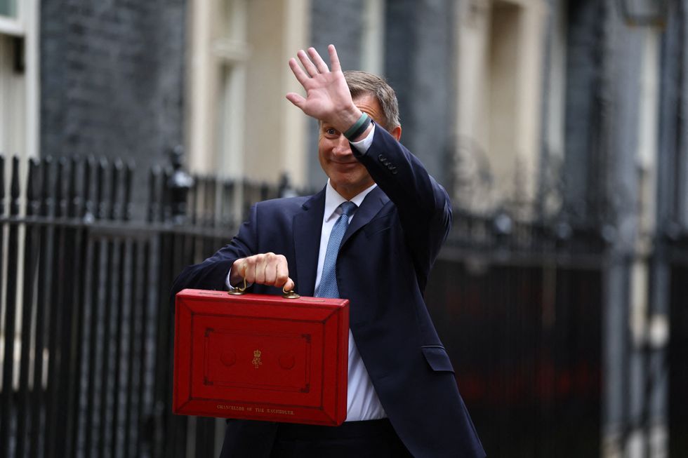 Jeremy Hunt holds the budget box outside Downing Street in London